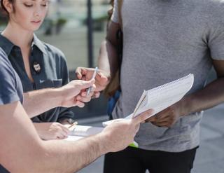 Man Giving Paper Sign